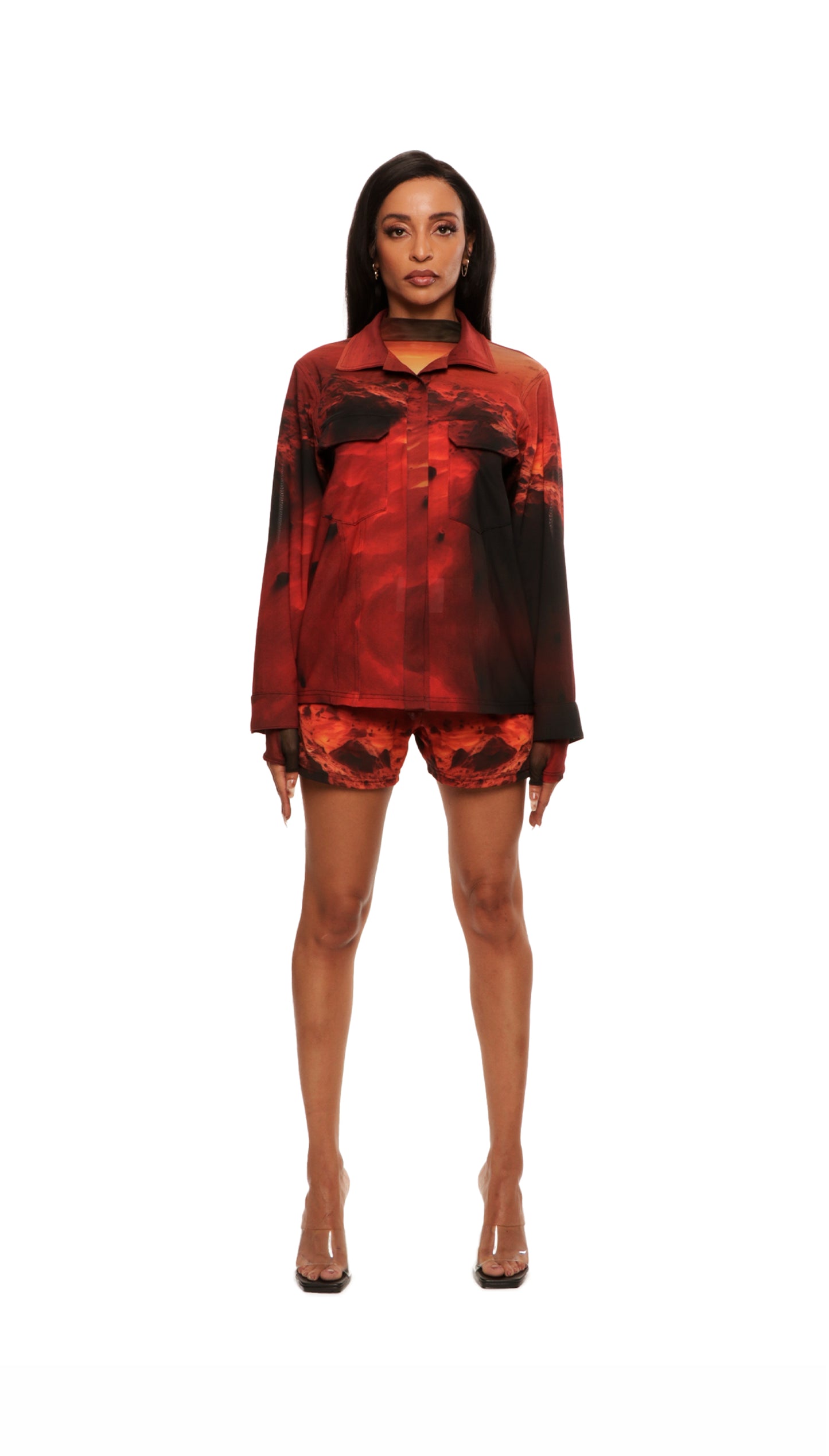 Woman who looks like Beyoncé or Aaliyah wears a cosmic sunset printed long sleeve button up shirt with snaps, front view closed