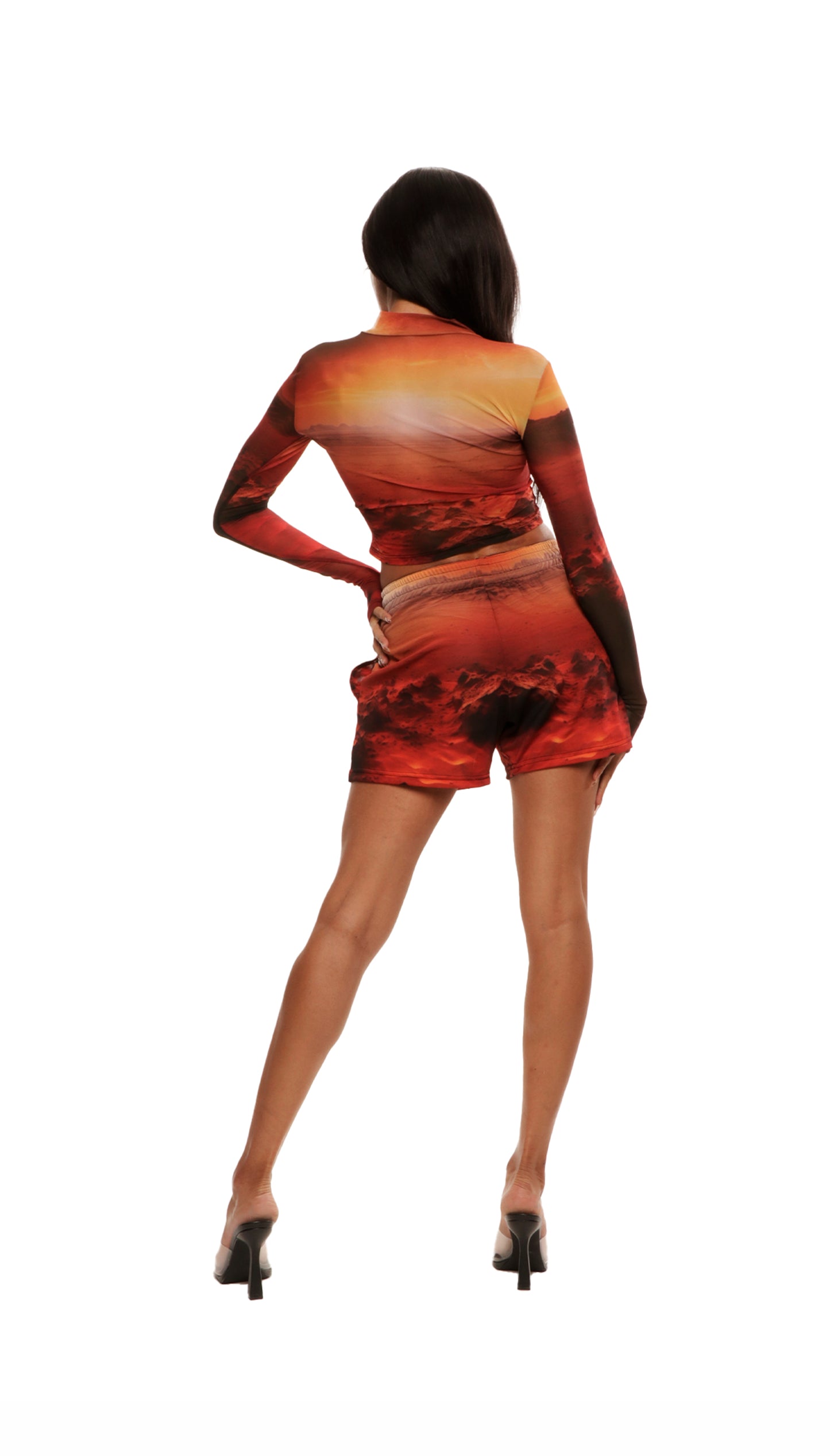 Back view of woman who looks like Beyoncé or Aaliyah wears cosmic Mars sunset printed mesh short basketball shorts QR logo detail