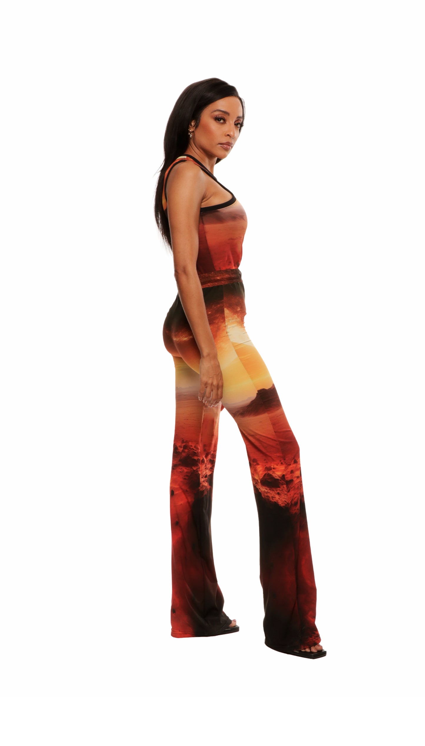 Woman who looks like Beyoncé or Aaliyah wears cosmic Mars sunset printed wide leg pant, side view