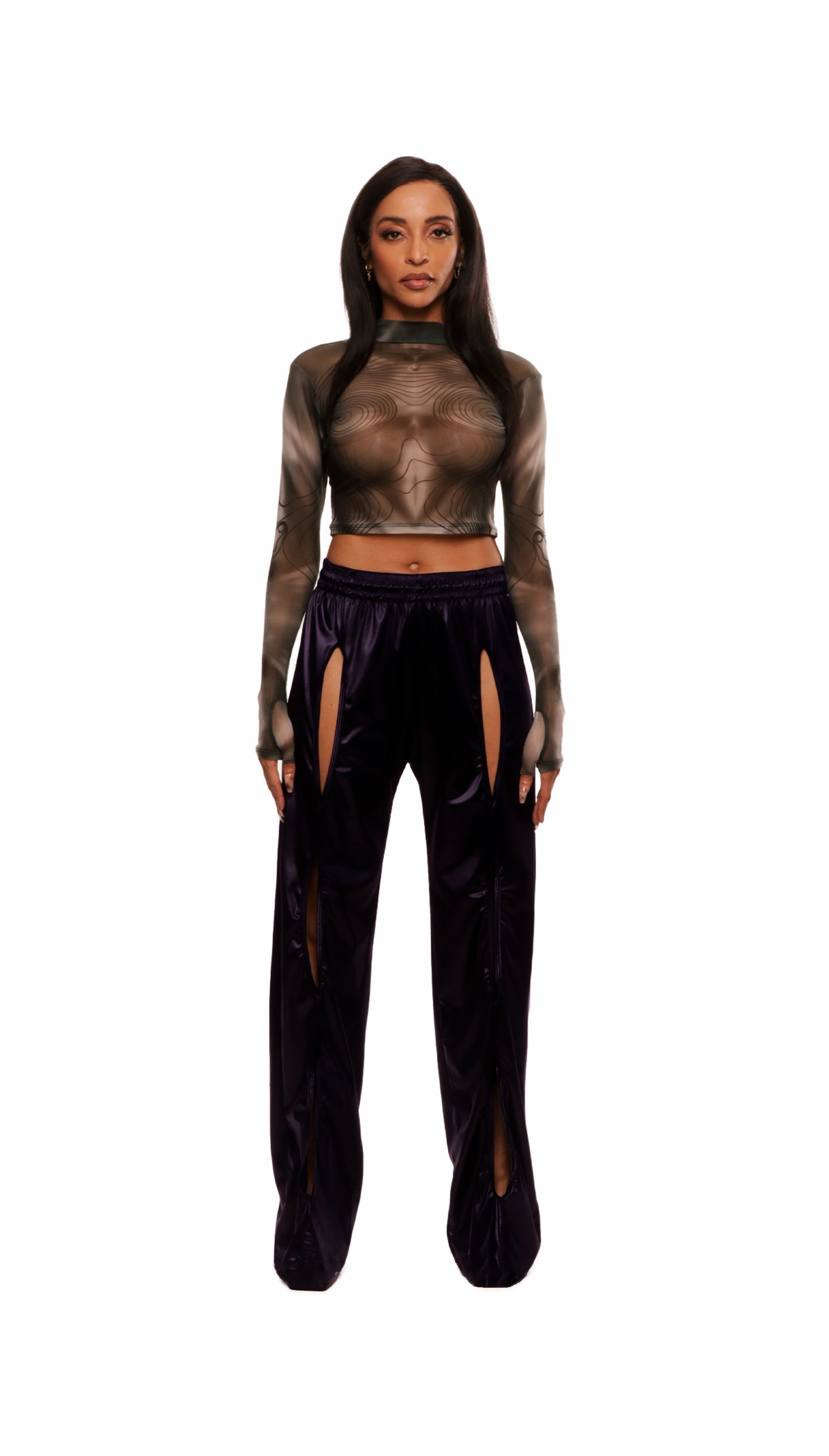 Woman who looks like Beyoncé or Aaliyah wears a grey stretch mesh long sleeve top custom printed to contour the body and resemble an oil spill. Front view paired with shiny purple pants.