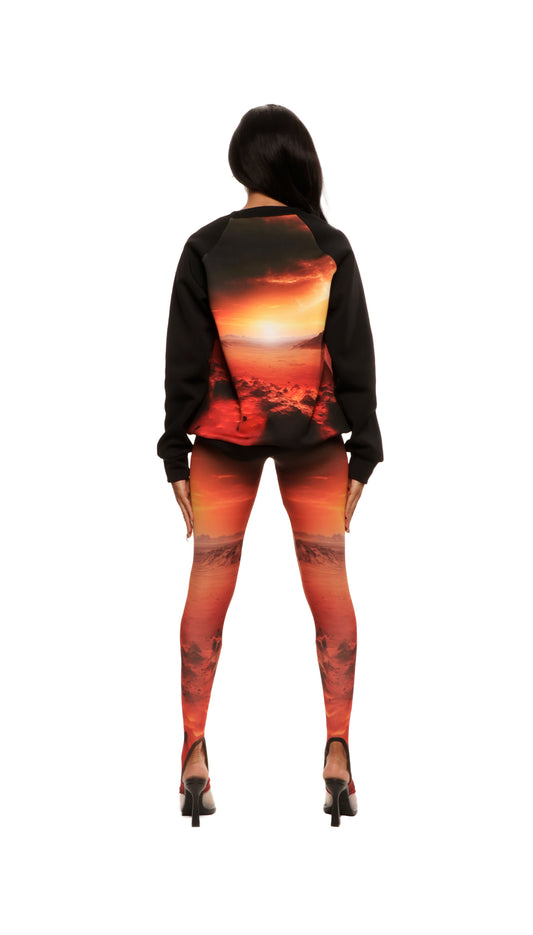 Woman who looks like Beyoncé or Aaliyah wears a cosmic mars sunset printed Italian fleece sweater with matching leggings, back view
