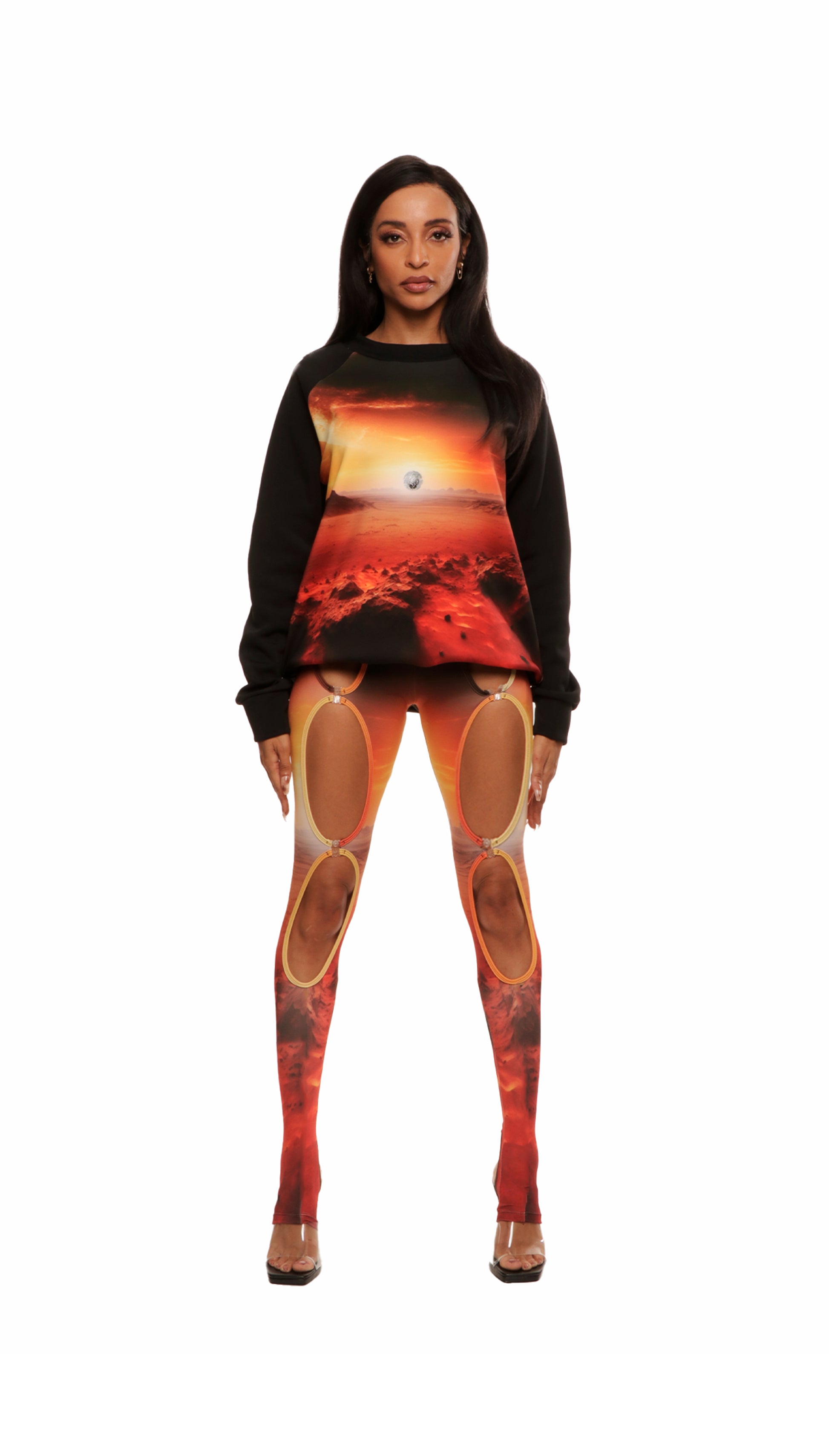 Woman who looks like Beyoncé or Aaliyah wears a cosmic mars sunset printed Italian fleece sweater with matching leggings, front view