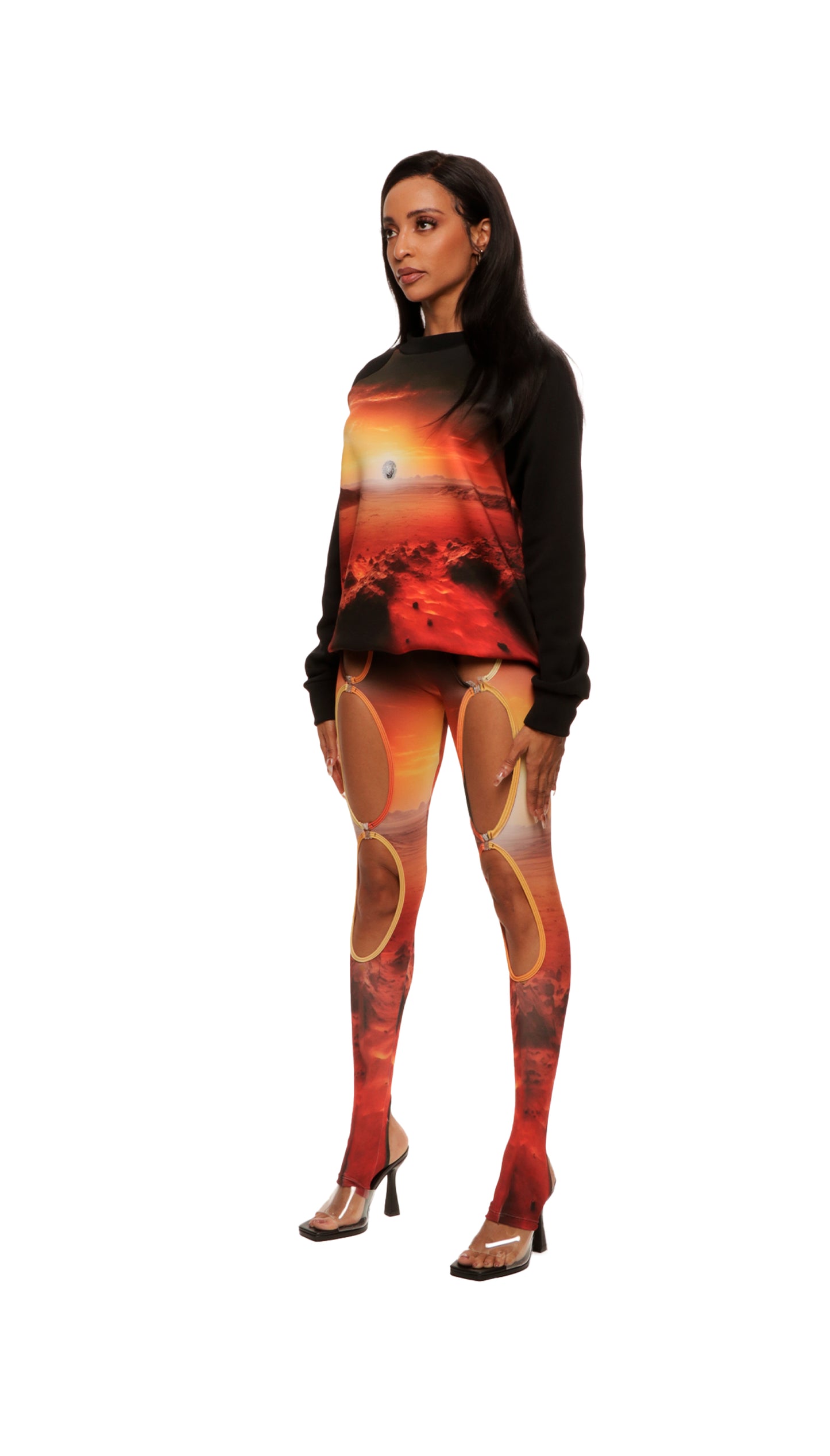 Woman who looks like Beyoncé or Aaliyah wears a cosmic mars sunset printed Italian fleece sweater with matching leggings, side view