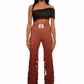 Woman who looks like Beyoncé or Aaliyah wears gradient brown toned bottoms or pants with cutout details on the sides, front view
