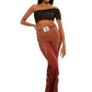 Woman who looks like Beyoncé or Aaliyah wears gradient brown toned bottoms or pants with cutout details on the sides, front view