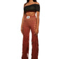 Woman who looks like Beyoncé or Aaliyah wears gradient brown toned bottoms or pants with cutout details on the sides, side view