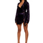  Woman who looks like Beyoncé or Aaliyah wears stretch cooling smooth nylon mini skirt with adjustable open detail clasp front paired with matching top, left view.