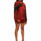 Woman who looks like Beyoncé or Aaliyah wears a cosmic sunset printed long sleeve button up shirt with snaps, side view