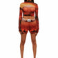 Front view of woman who looks like Beyoncé or Aaliyah wears cosmic Mars sunset printed mesh short basketball shorts QR logo detail