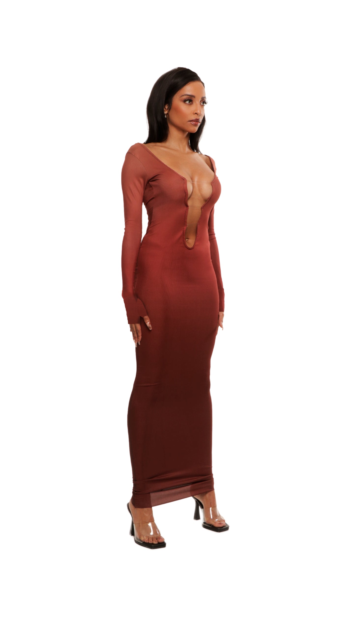 Woman who looks like Beyoncé or Aaliyah wears bodycon brown gradient printed stretch rib knit maxi dress with gauntlet sleeve detail and adjustable deep 'v' neckline. Right view.