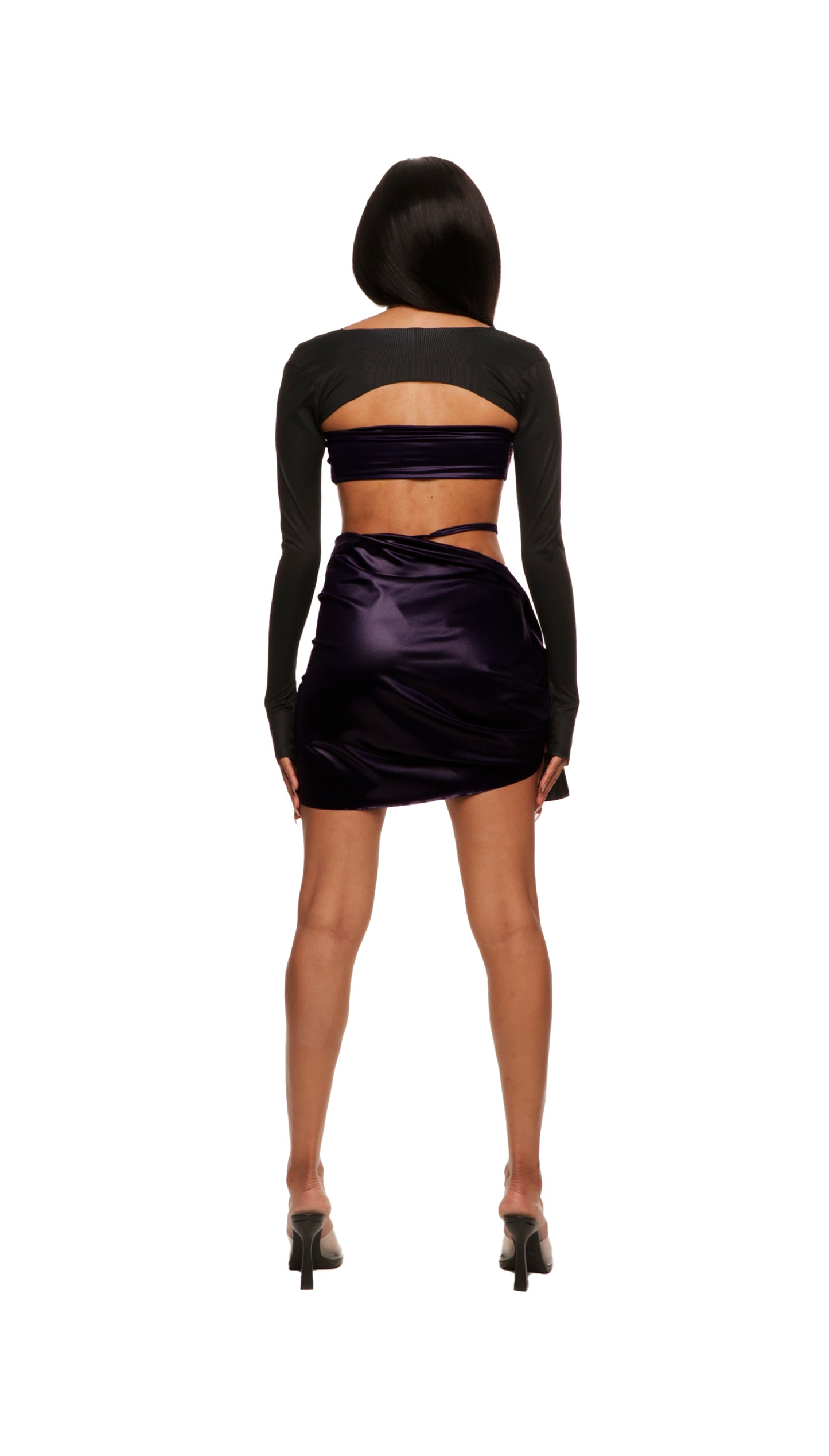 Woman who looks like Beyoncé or Aaliyah wears berry colored stretch cooling smooth nylon bikini top with adjustable clear straps for comfortability, paired with matching skirt and bikini bottom, back view.