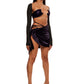 Woman who looks like Beyoncé or Aaliyah wears a berry colored stretch cooling smooth nylon asymmetrical ruched mini skirt with matching bikini top, right view.