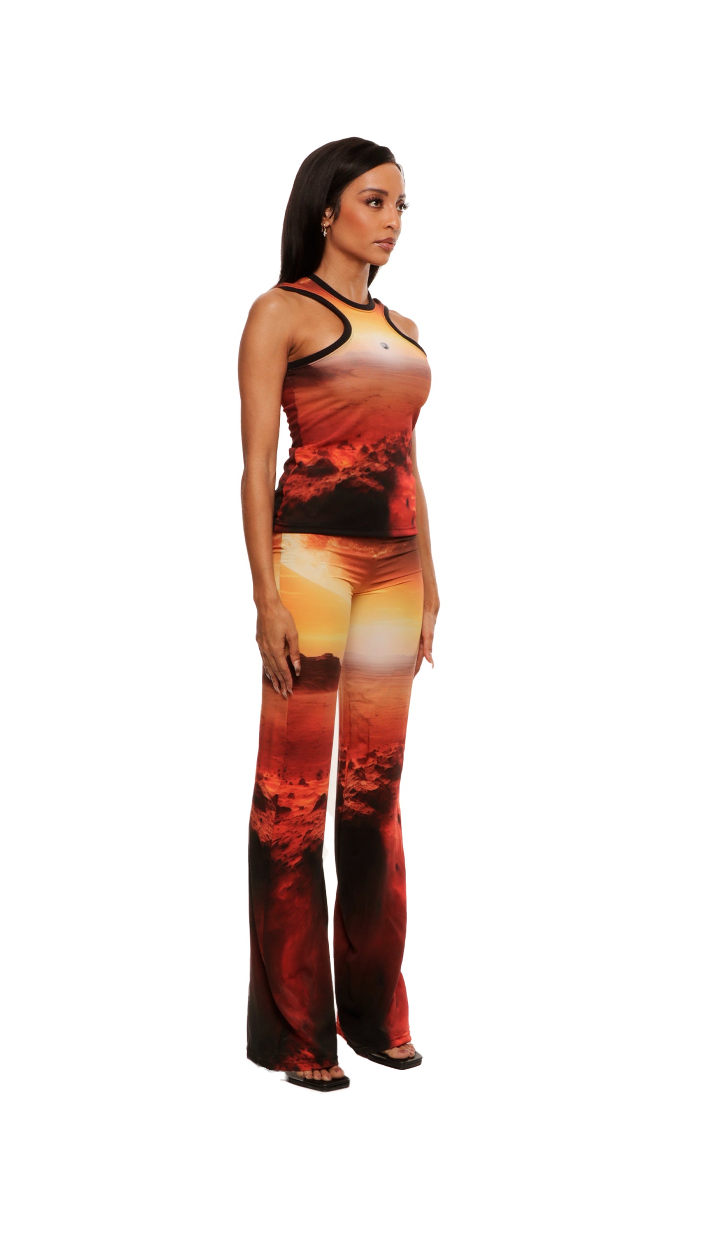 Woman who looks like Beyoncé or Aaliyah wears a sleeveless sunset on Mars printed compression mesh top with razor neck detail 