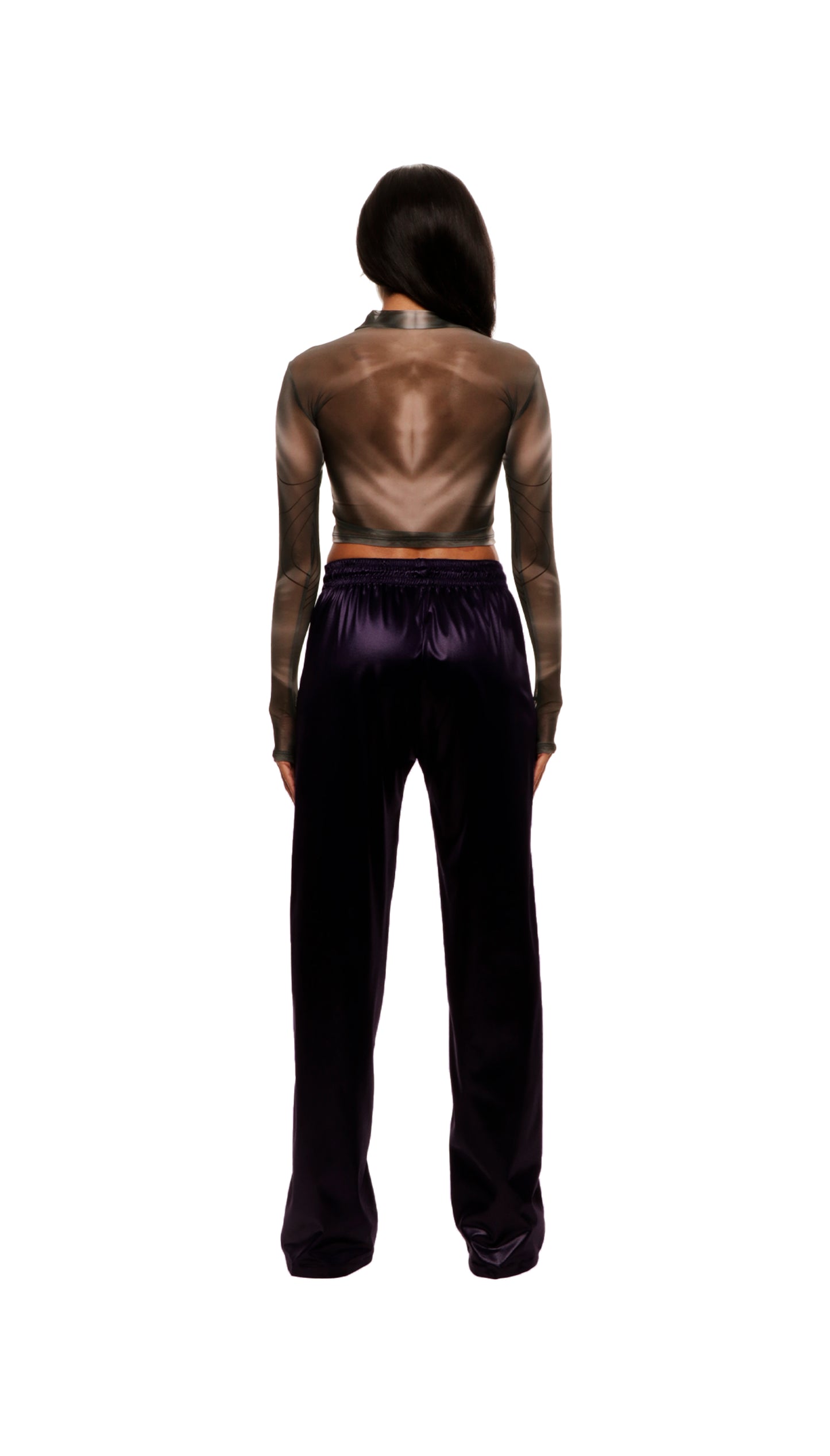 Woman who looks like Beyoncé or Aaliyah wears a grey stretch mesh long sleeve top custom printed to contour the body and resemble an oil spill. Back view paired with shiny purple pants.