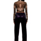 Woman who looks like Beyoncé or Aaliyah wears berry colored stretch smooth nylon pants with open detail front, paired with a grey stretch mesh long sleeve shirt top. Back view.