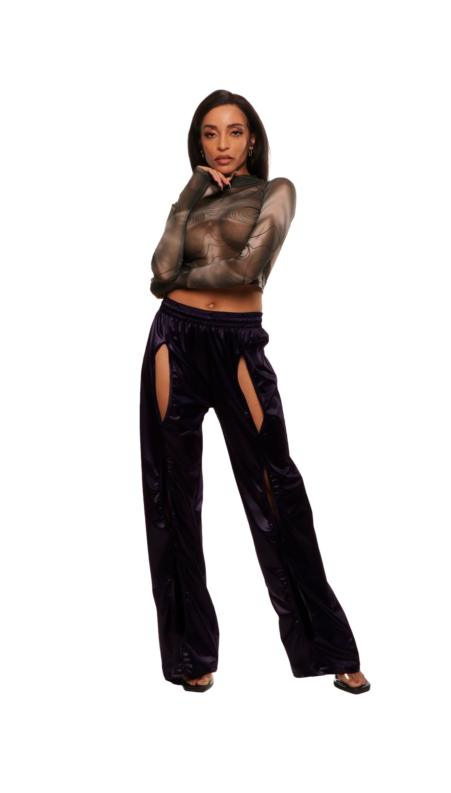 Woman who looks like Beyoncé or Aaliyah wears berry colored stretch smooth nylon pants with open detail front, paired with a grey stretch mesh long sleeve shirt top. Front view.