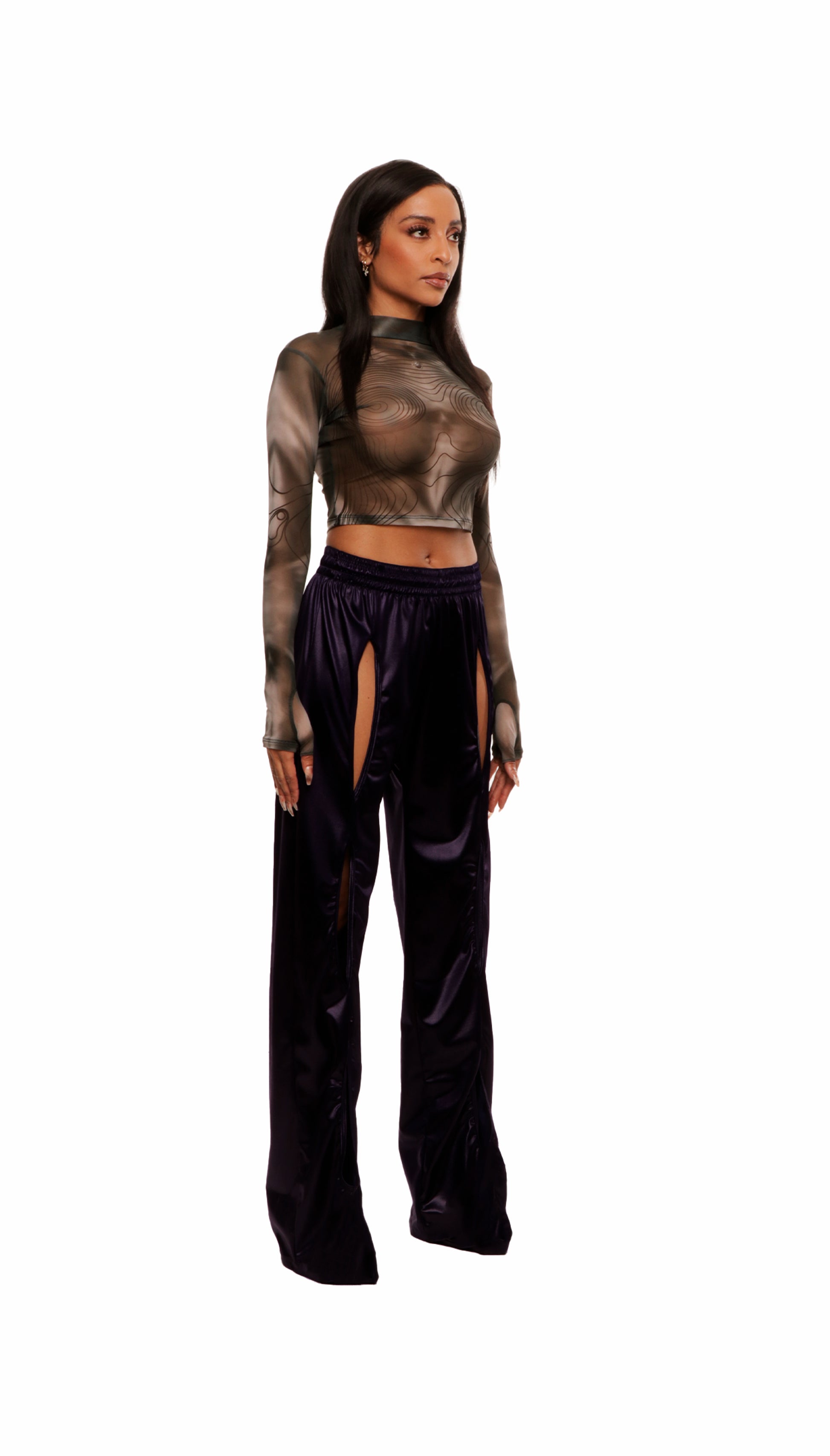 Woman who looks like Beyoncé or Aaliyah wears a grey stretch mesh long sleeve top custom printed to contour the body and resemble an oil spill. Right view paired with shiny purple pants.