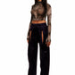 Woman who looks like Beyoncé or Aaliyah wears berry colored stretch smooth nylon pants with open detail front, paired with a grey stretch mesh long sleeve shirt top. Left view.