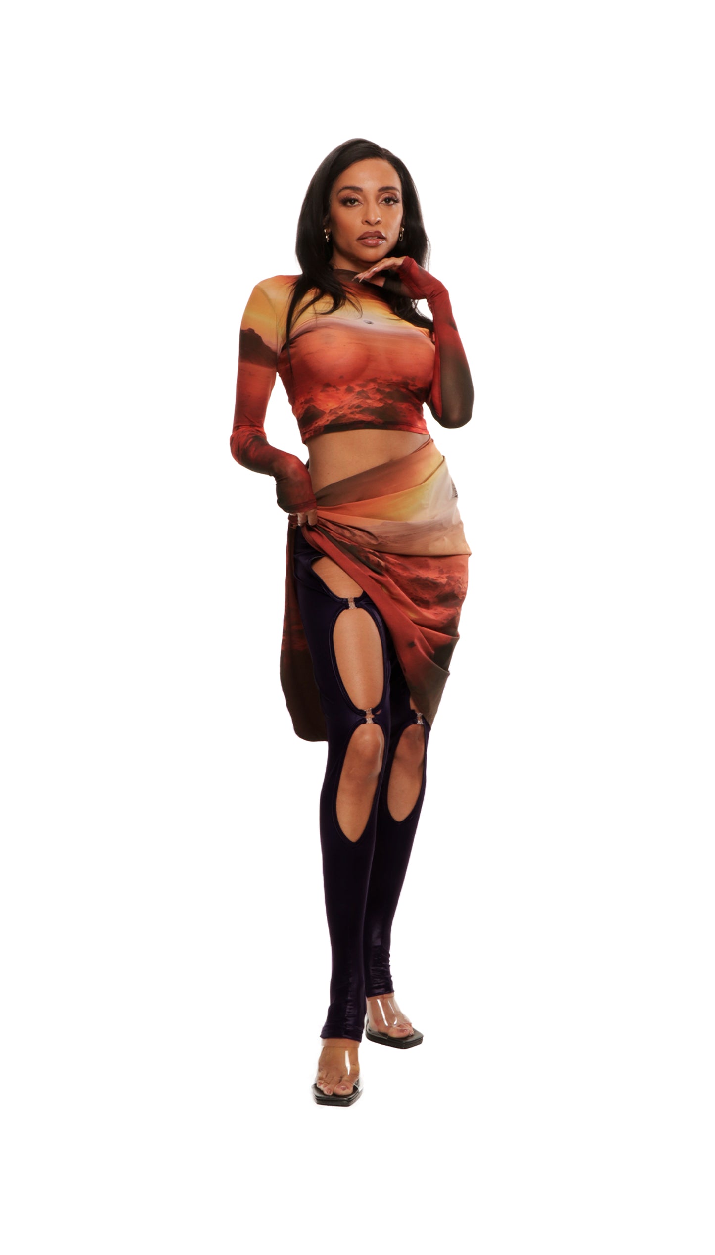  Woman who looks like Beyoncé or Aaliyah wears berry colored stretch cooling smooth nylon leggings with open detail clasp front and stirrup style opening, side view. Paired with sunset on Mars printed long sleeve top.
