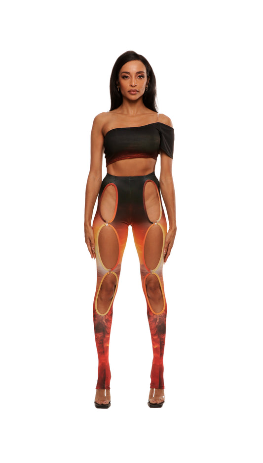 Woman who looks like Beyonce or Aaliyah wears sunset printed jersey leggings with cutout details in the front attached with snaps and heel cutout