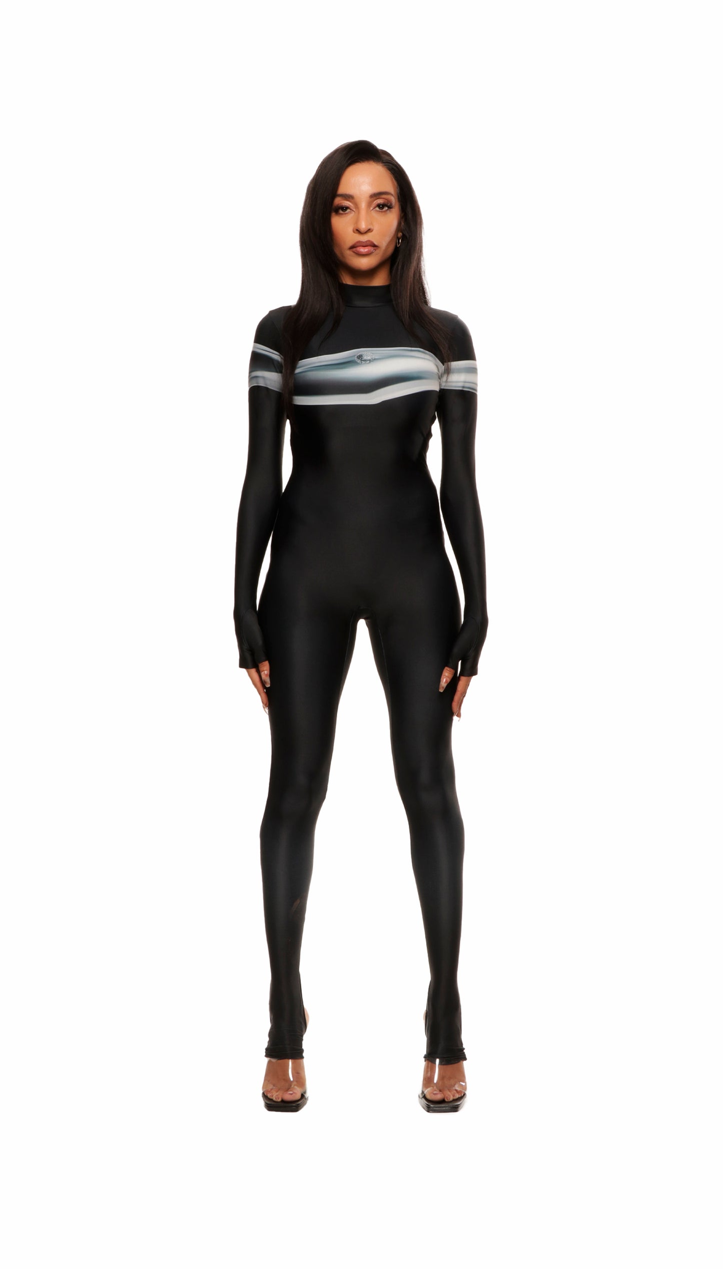 Woman wears black printed wetsuit or catsuit with chrome detail across chest and QR logo with heel cutout Beyonce, Rihanna, Aaliyah