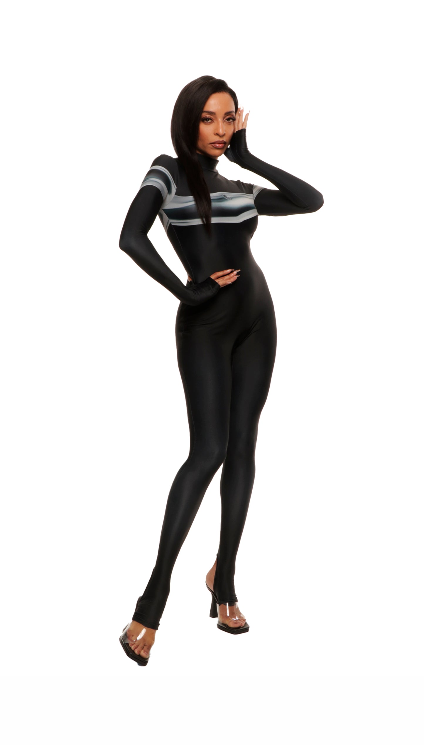 Woman wears black printed wetsuit or catsuit with chrome detail across chest and QR logo with heel cutout