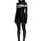 Woman wears black printed wetsuit or catsuit with chrome detail across chest and QR logo with heel cutout
