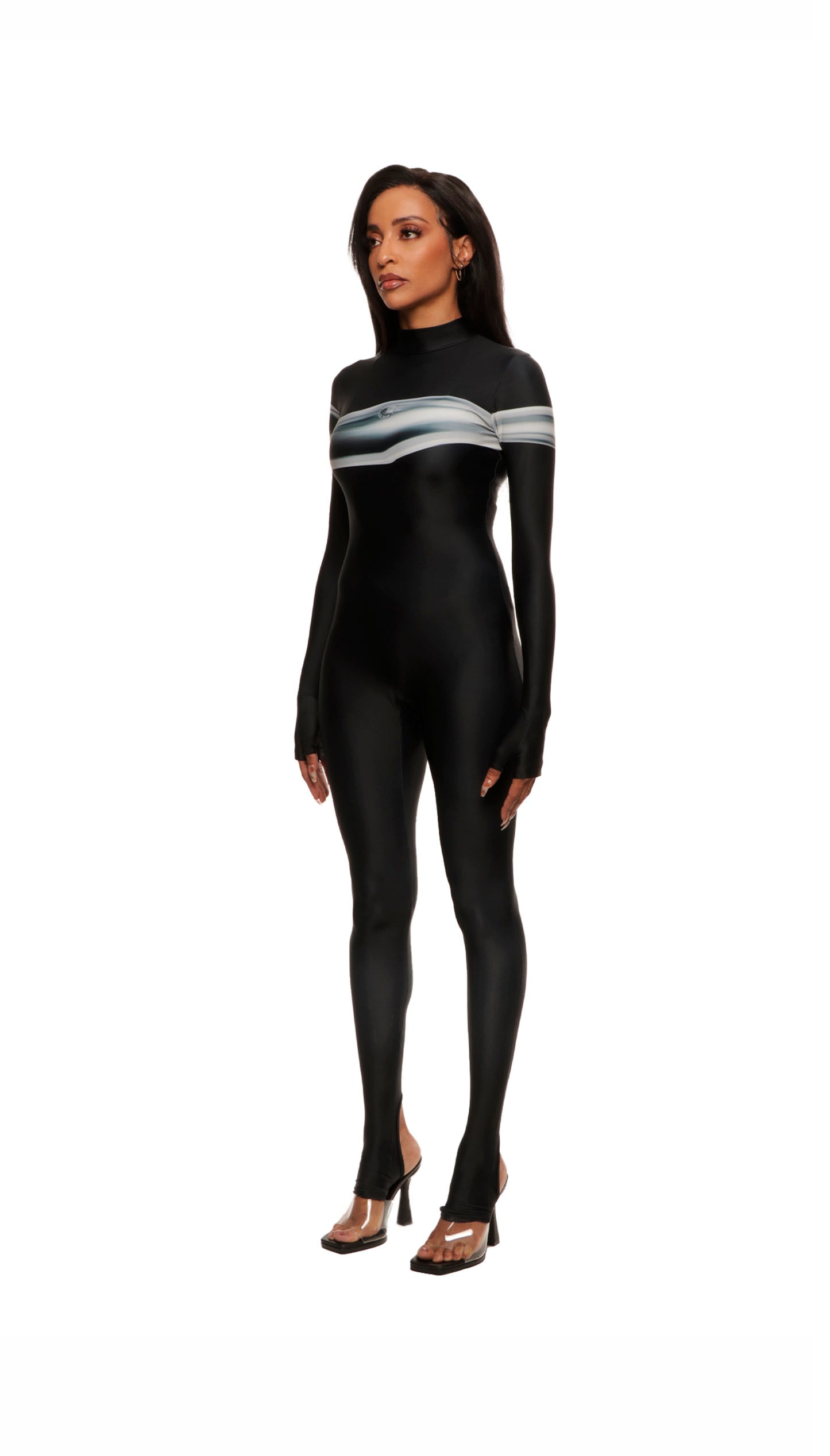 Woman wears black printed wetsuit or catsuit with chrome detail across chest and QR logo with heel cutout