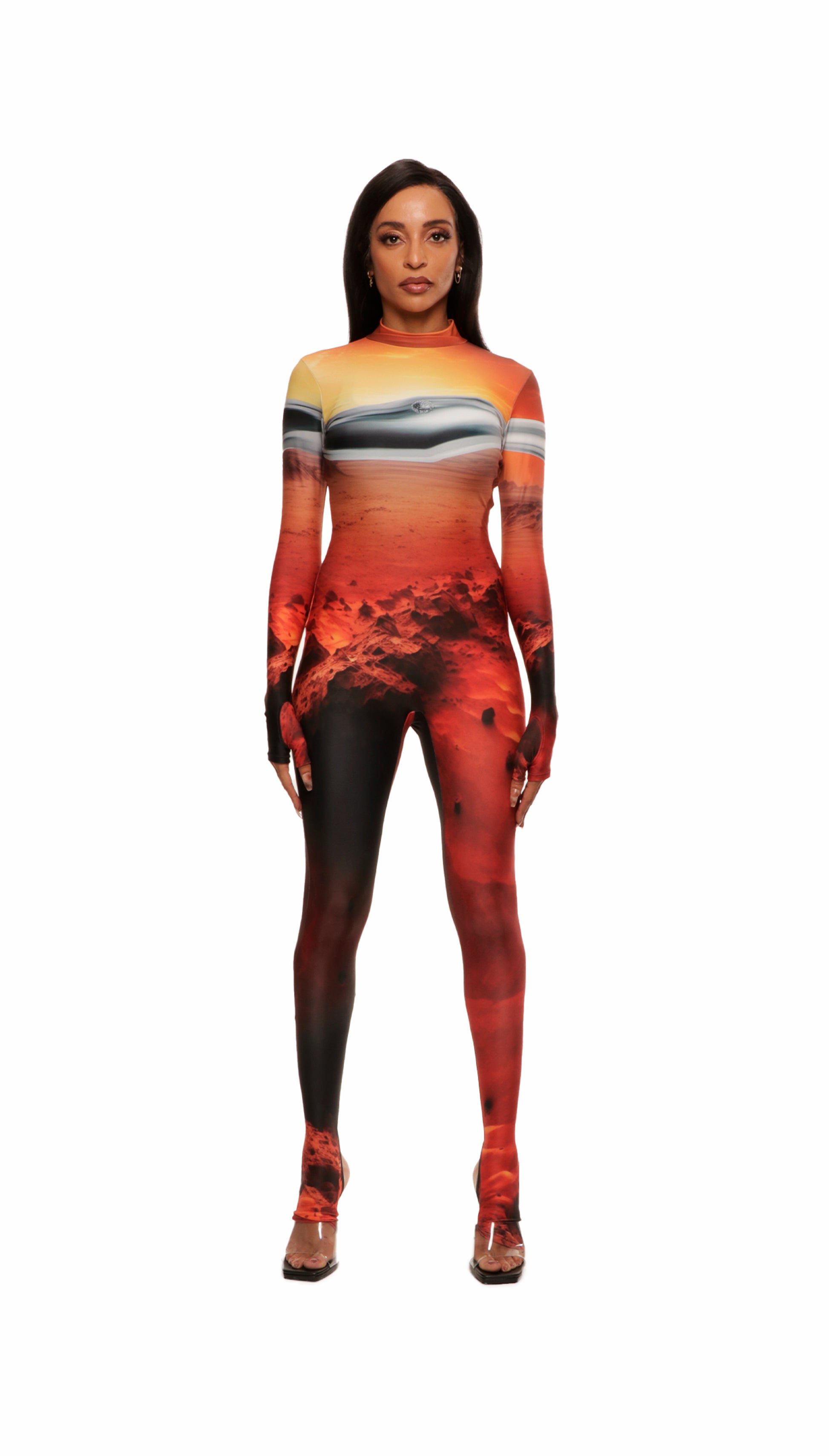 Woman wears Mars sunset print wetsuit or catsuit with chrome detail across chest and QR logo with heel cutout