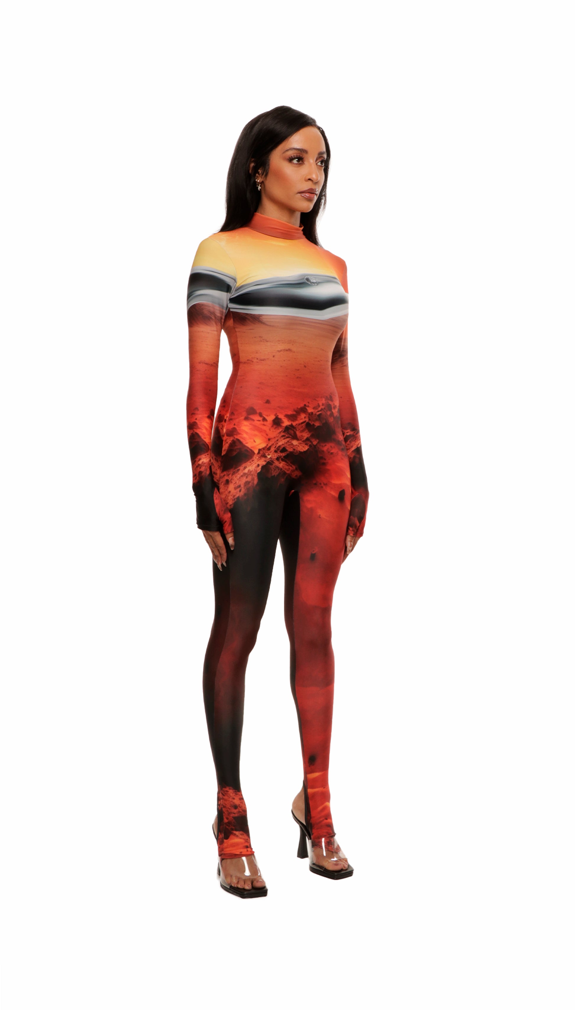 Woman wears Mars sunset print wetsuit or catsuit with chrome detail across chest and QR logo with heel cutout