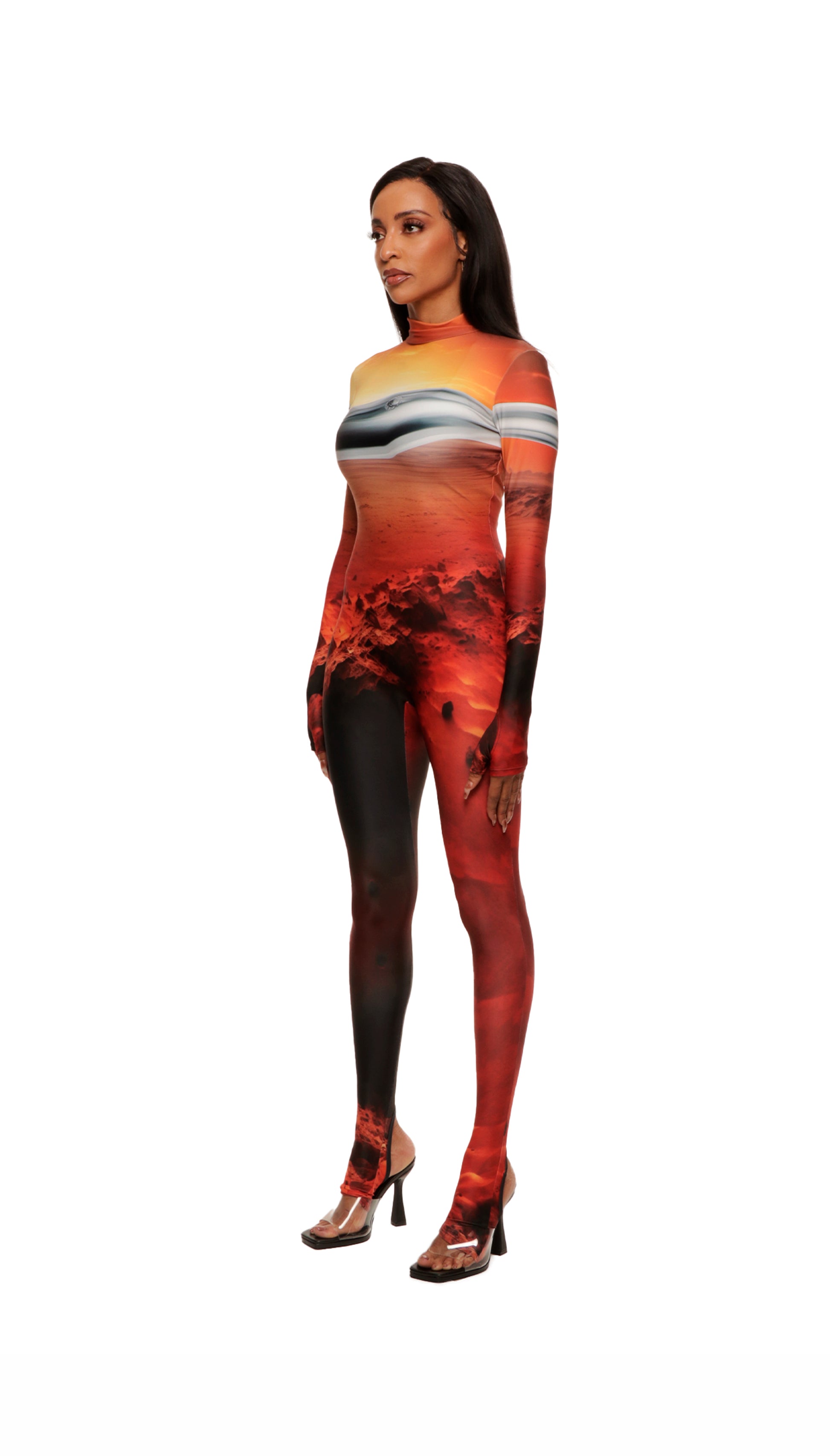 Woman wears Mars sunset print wetsuit or catsuit with chrome detail across chest and QR logo with heel cutout